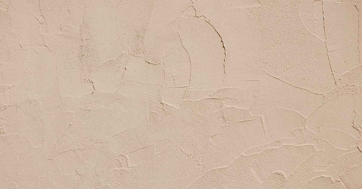 Beige textured synthetic stucco wall finish surface
