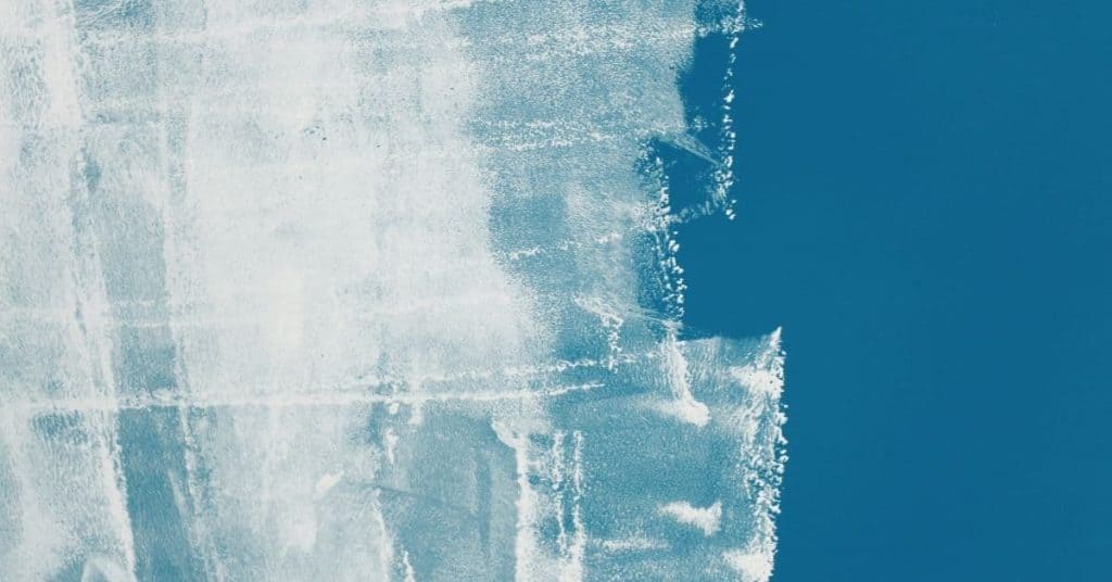 Partially painted blue wall with visible brush strokes