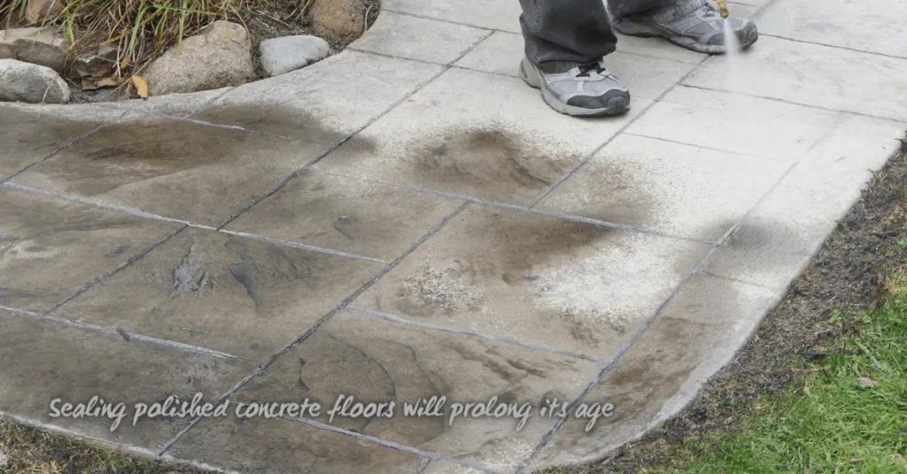 Person applying water to sealed concrete patio outdoors