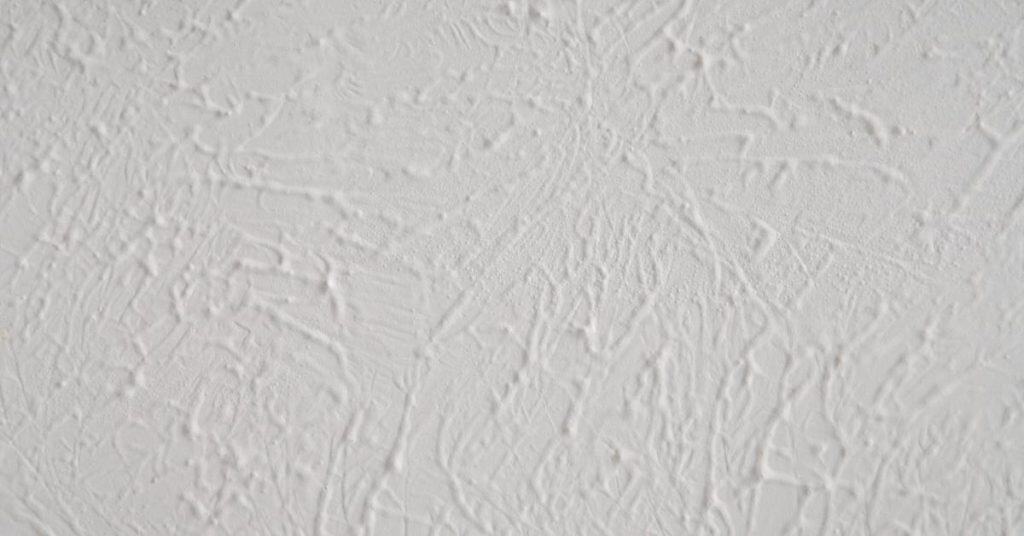 Close-up of white textured plaster surface on drywall
