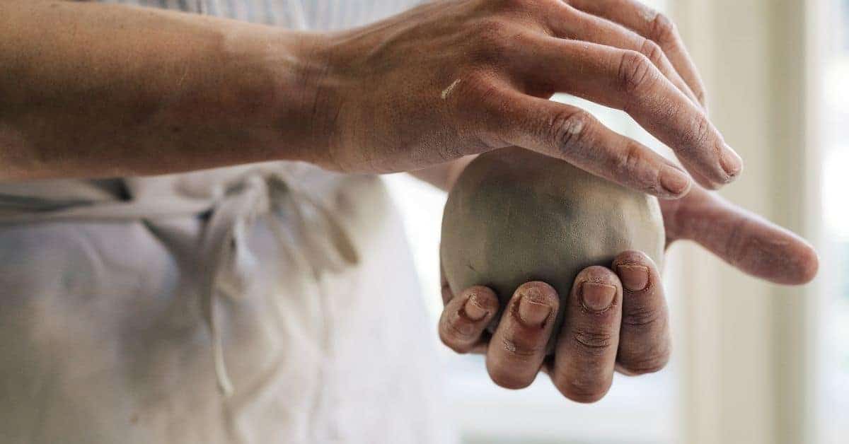 Hand shaping a smooth ball of plaster