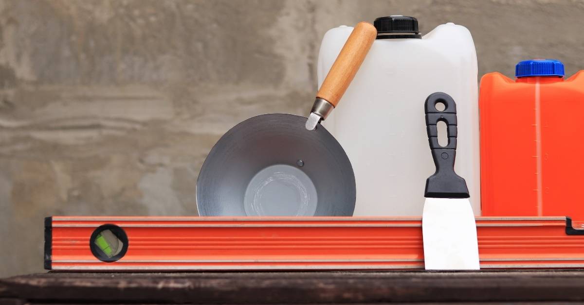 level trowel mixing buckets and scraper on table