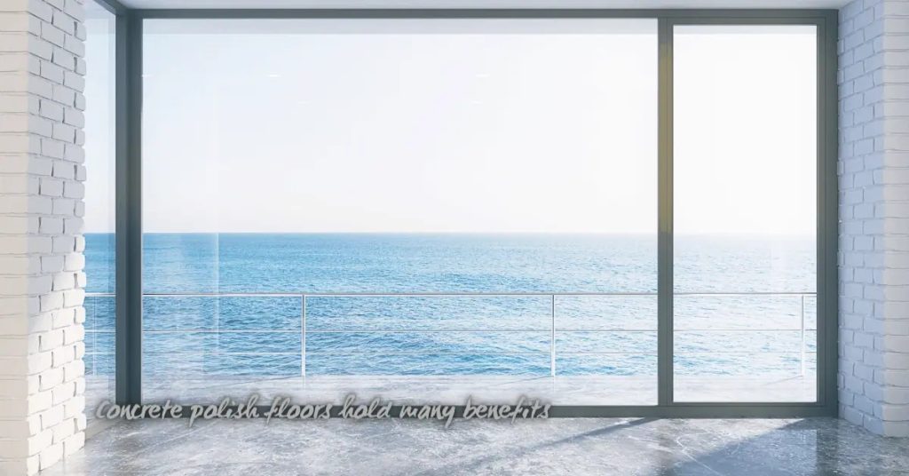 polished concrete floor with large glass window overlooking sea