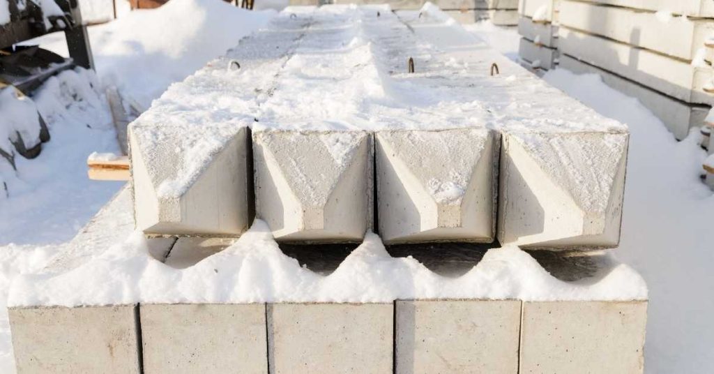 Precast concrete beams covered with snow outdoors