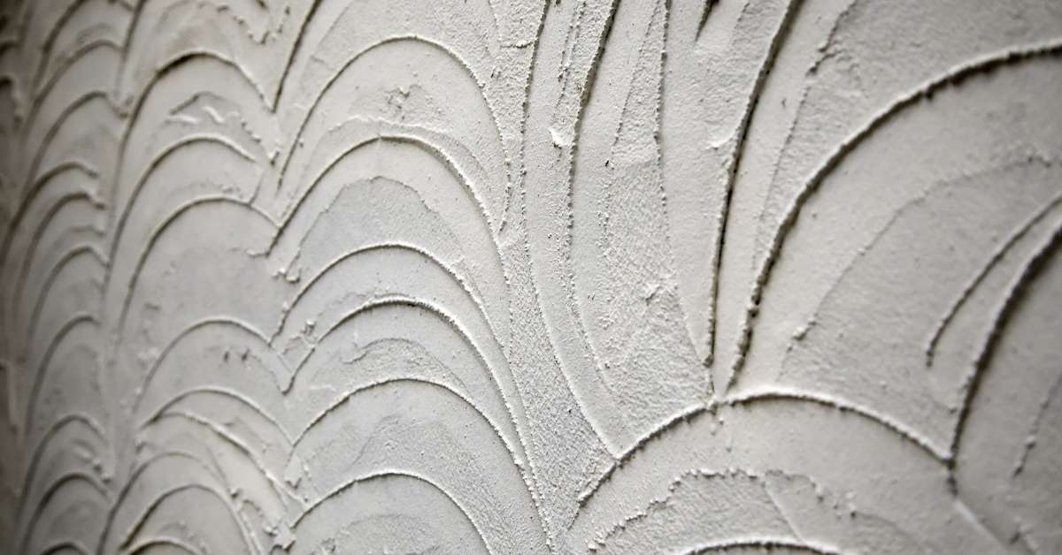 close-up of curved textured gray stucco wall surface