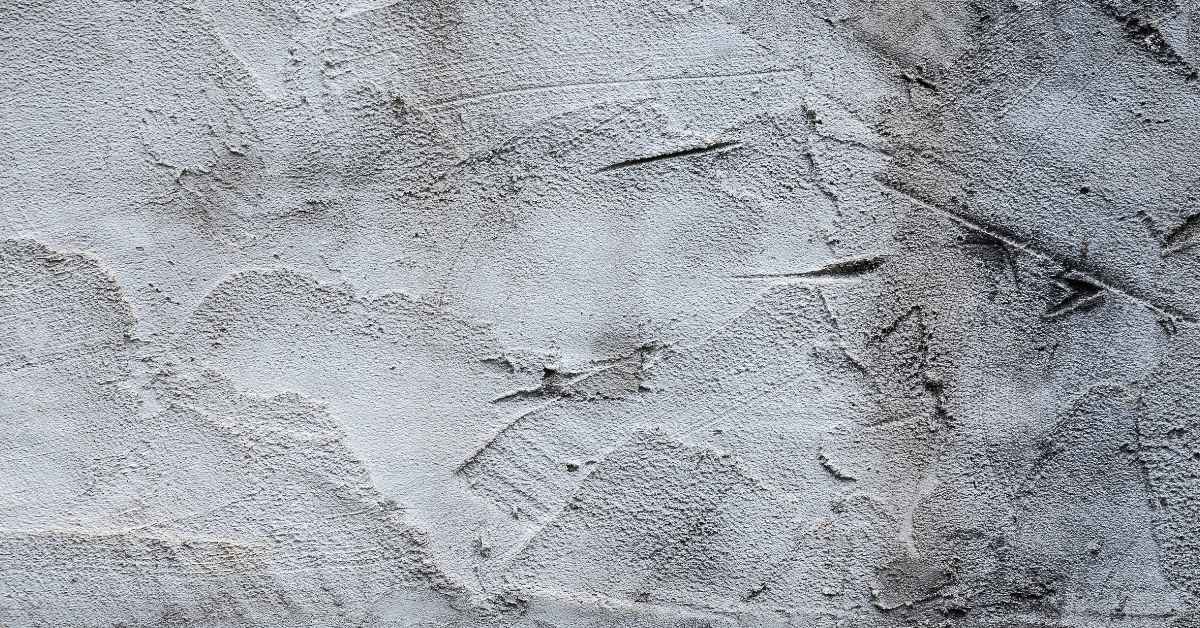 closeup of rough gray stucco texture on wall surface