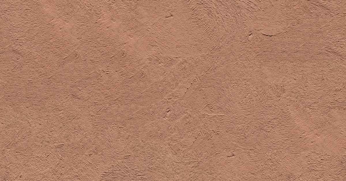 Close-up of textured brown stucco wall surface