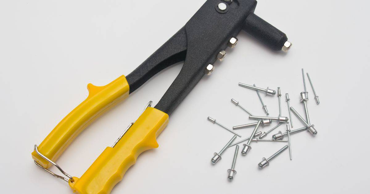 hand riveter tool with yellow handles and metal rivets