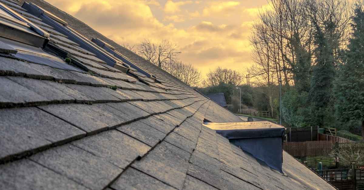 Slate roof with metal flashing around roof penetration vent