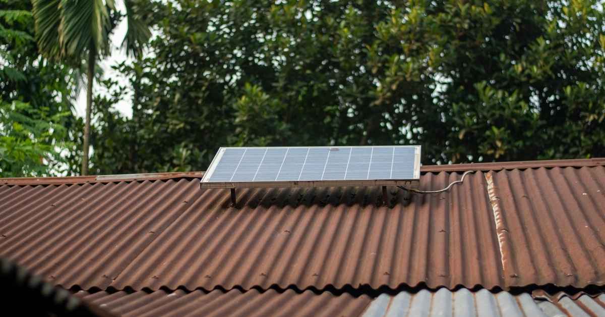 Solar panel mounted on rusty corrugated metal roofing