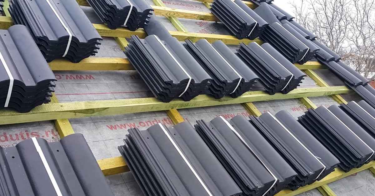 Stacks of concrete roof tiles on wooden battens on roof