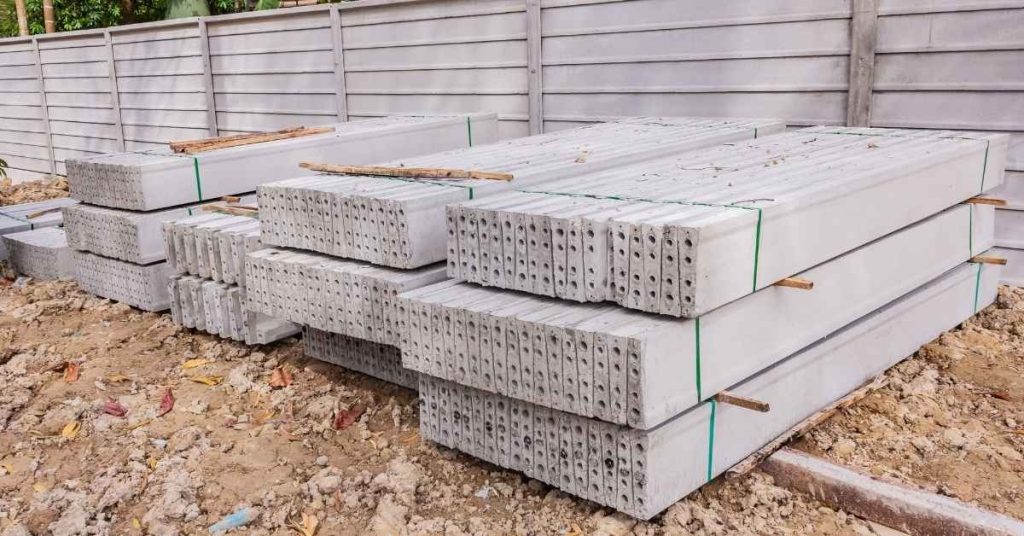 Stacked precast concrete hollow core slabs on dirt ground