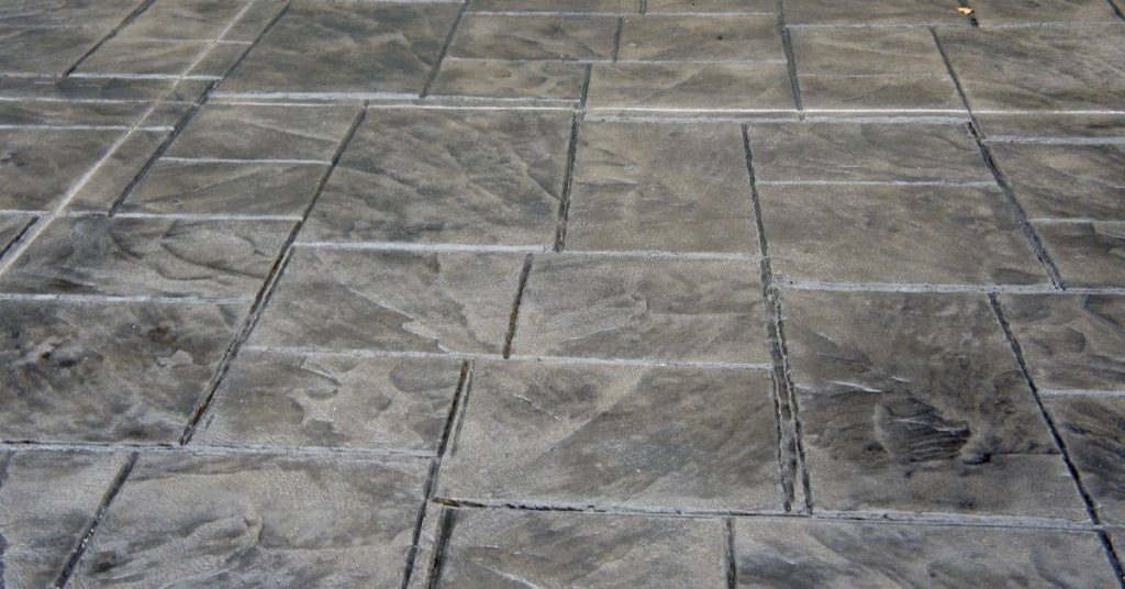 Stamped concrete patio surface with gray color and texture