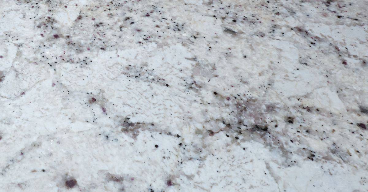 closeup of white granite stone surface with speckles