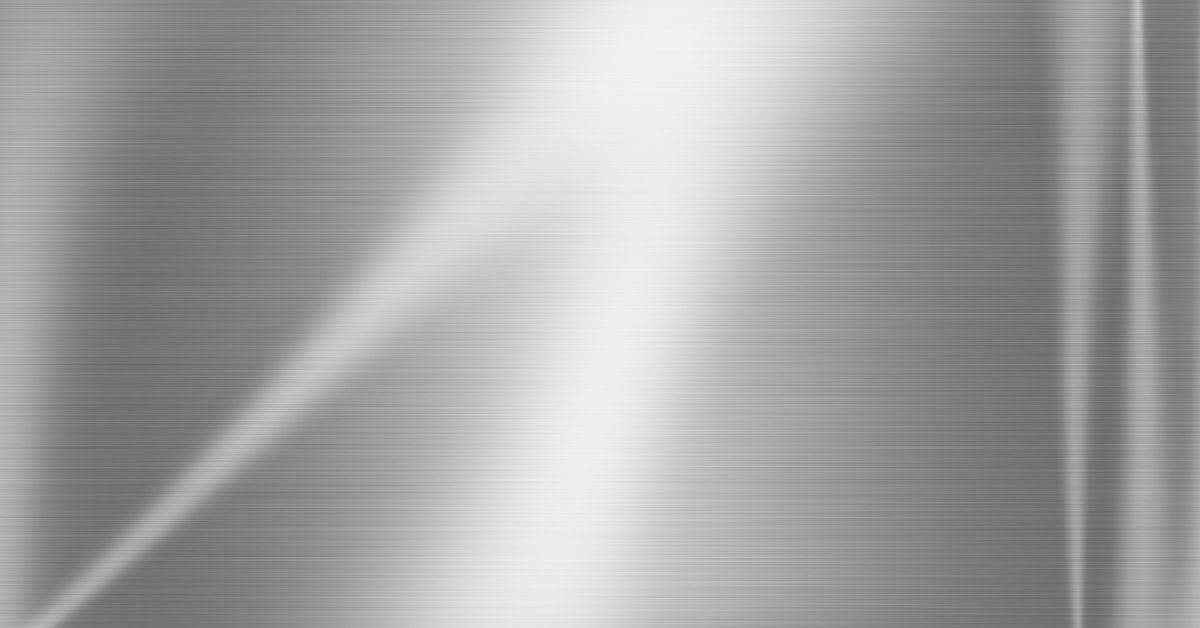 Close-up of brushed metal sheet surface with linear texture