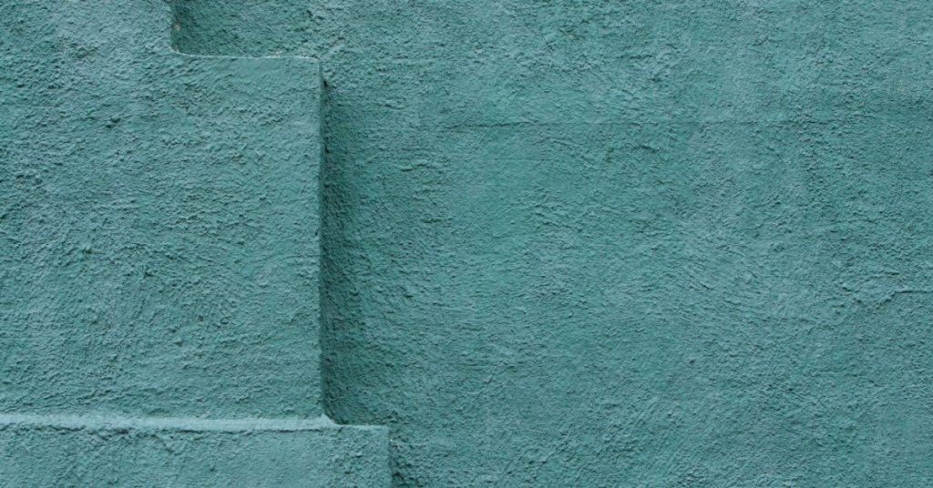 Textured blue stucco wall with recessed section