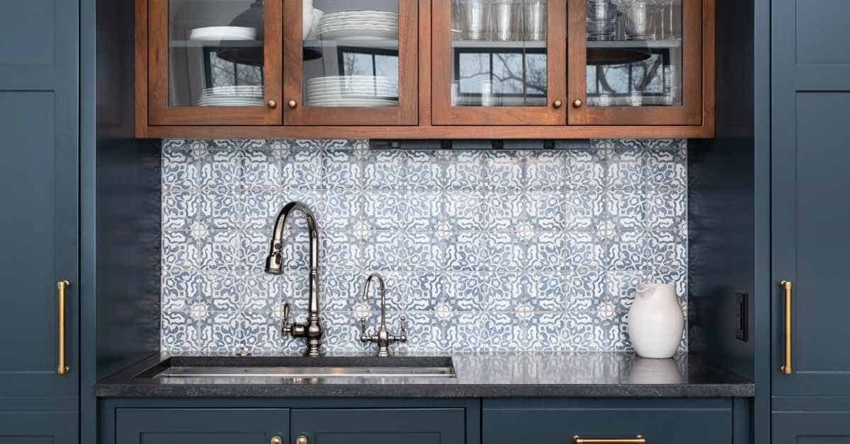 blue patterned ceramic tile backsplash behind kitchen sink