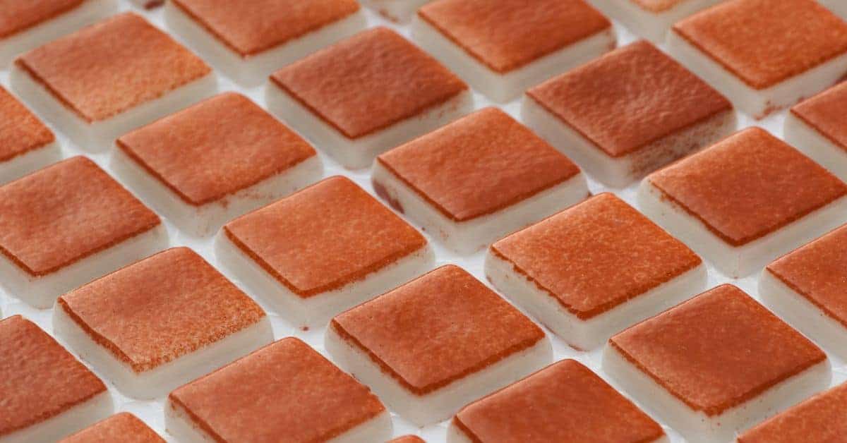 Close-up of red glass mosaic tiles arranged in grid pattern