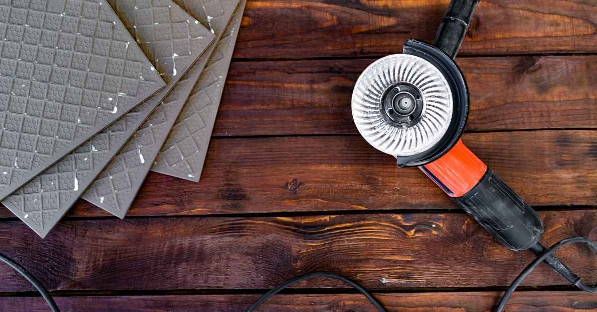 Angle grinder tool and textured tiles on wooden surface