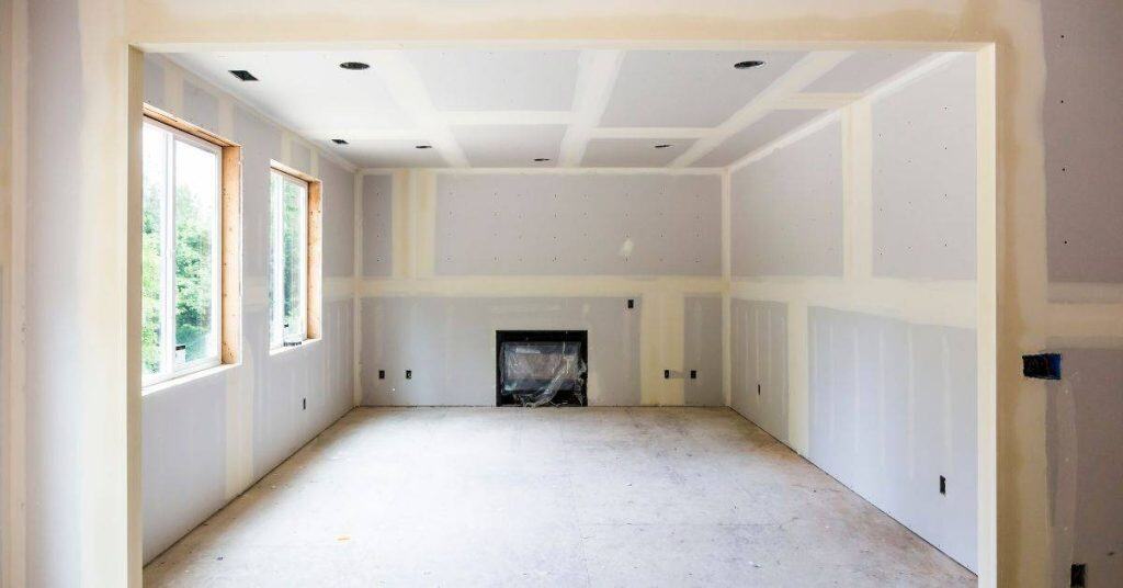 Unfinished room with drywall and no flooring installed