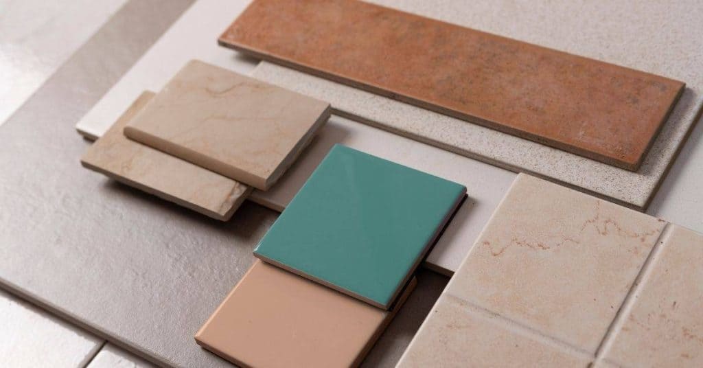 Various ceramic and porcelain tile samples arranged on a surface