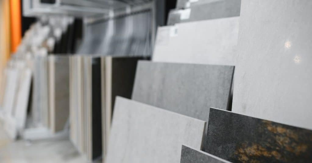 Various large tile samples displayed upright in a store
