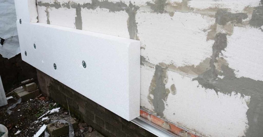 White EPS foam board attached to exterior masonry wall