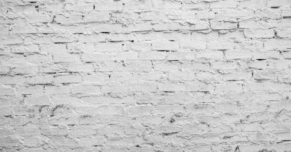 White stucco coated brick wall texture close-up