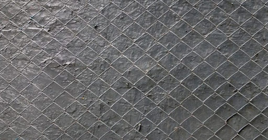 Wire mesh secured flat on wet cement surface