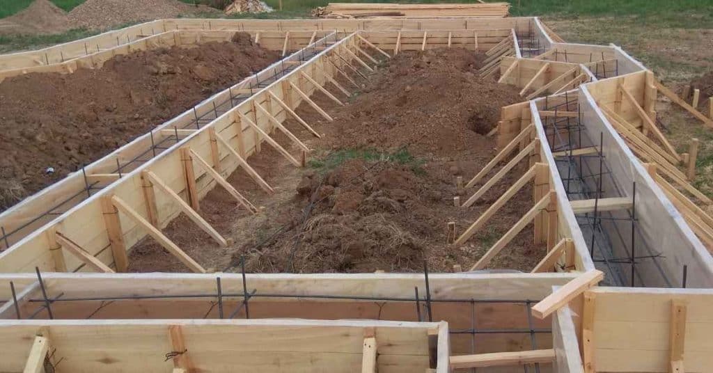 Wooden concrete forms with metal rebar inside trenches