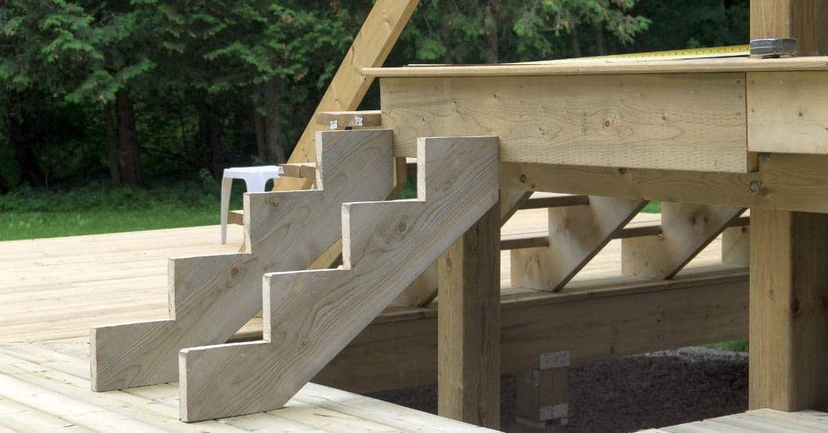 Wooden stair stringers supporting an outdoor deck