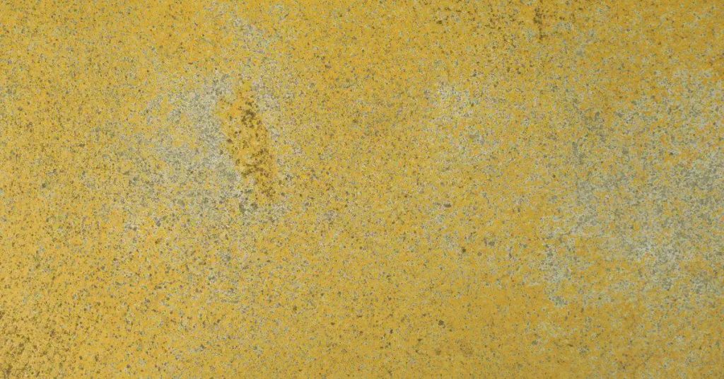 yellow stained concrete surface with varying texture