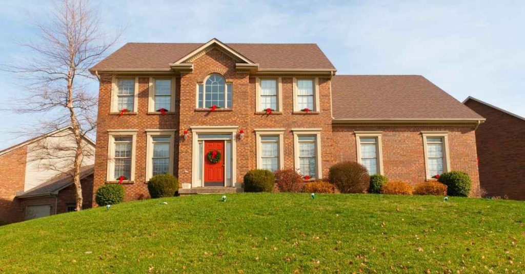 Brick two-story house exterior with windows and front door