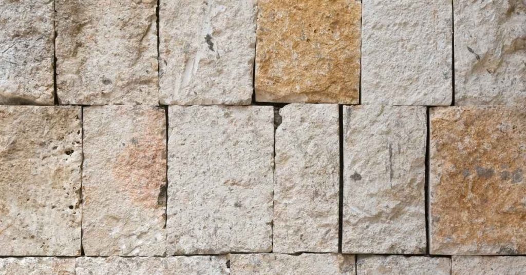 Close-up of rough cut limestone blocks arranged in a wall