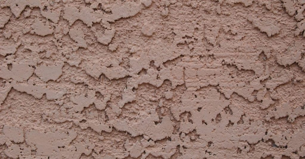 Close-up of textured brown stucco wall surface