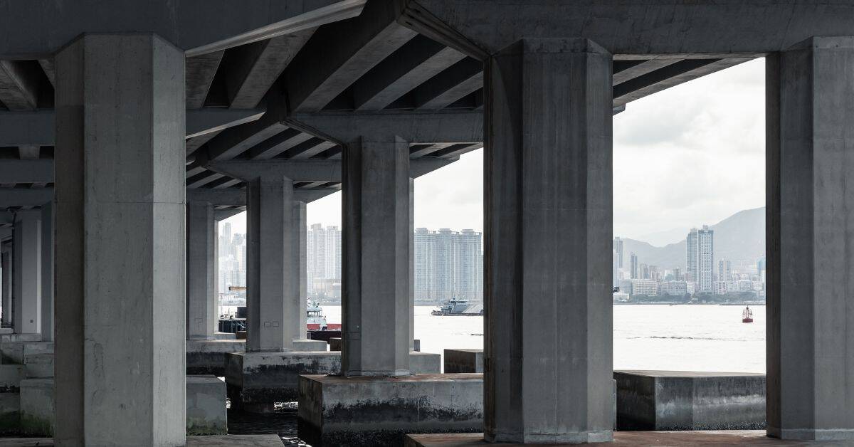 Concrete pier support columns under a bridge by waterfront