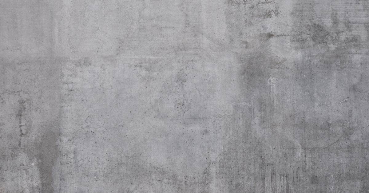 rough grey concrete wall texture with patches and stains