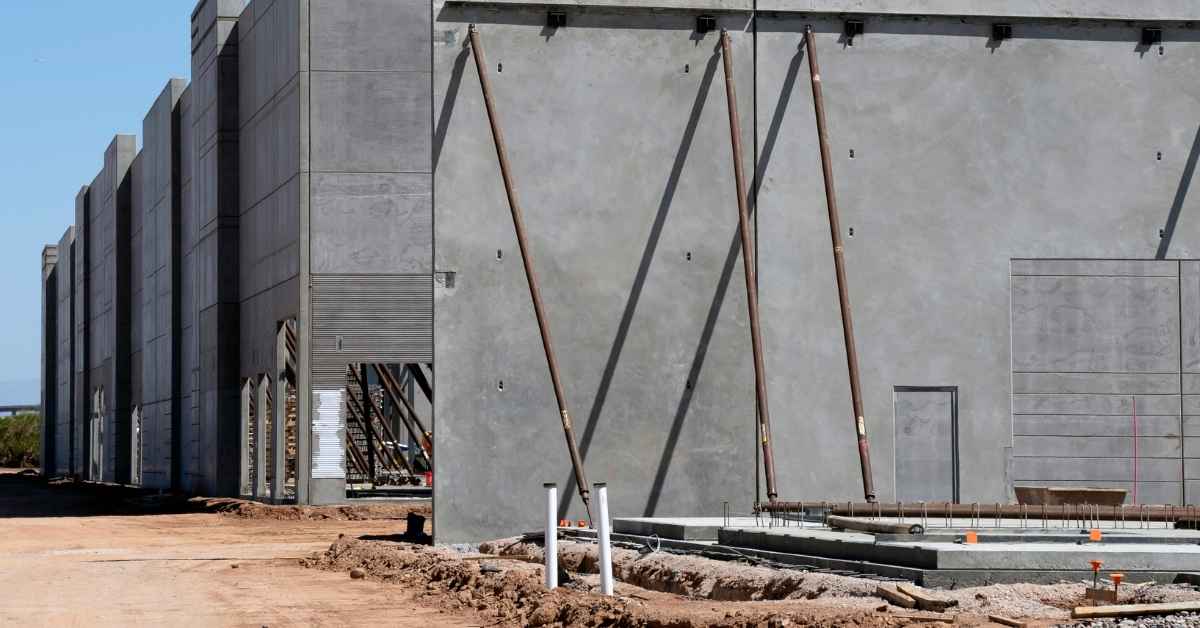 Concrete precast wall panels supported by braces at construction site
