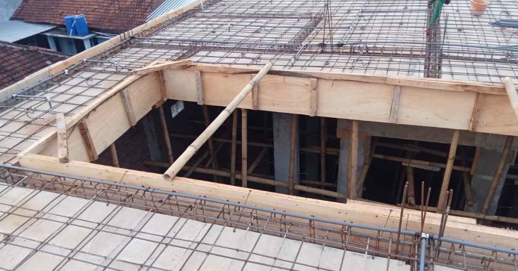 Concrete slab with wooden formwork and steel rebar grid