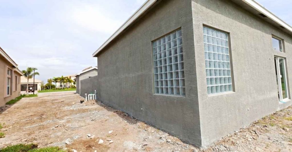 Corner of a stucco exterior wall with glass block windows