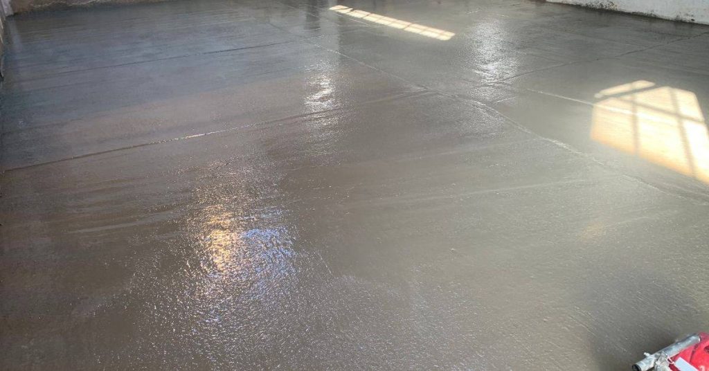 Freshly poured smooth concrete slab floor inside building