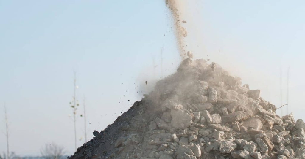 pile of crushed concrete pieces outdoors under clear sky