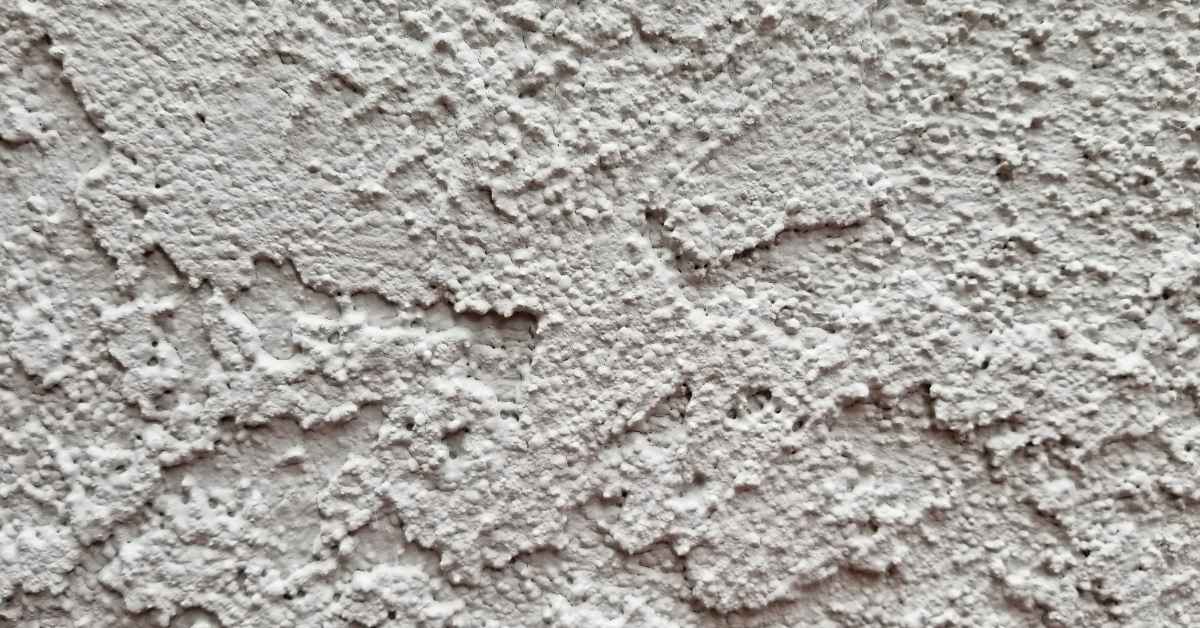 close-up of rough textured stucco surface with irregular pattern