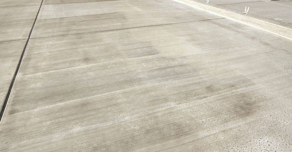 Smooth concrete driveway slab with visible expansion joints