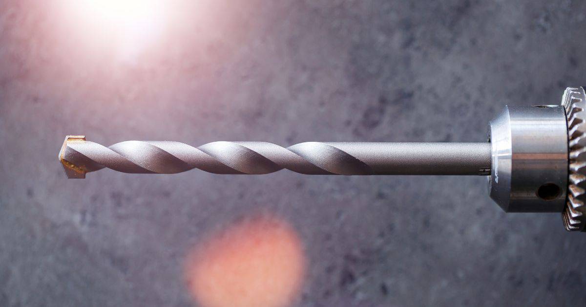 closeup of a drill bit attached to a drill chuck