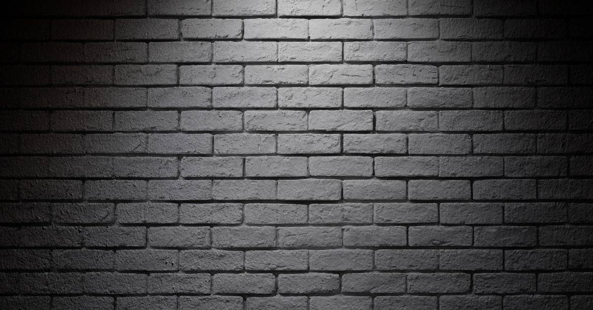 gray brick wall with mortar joints evenly arranged