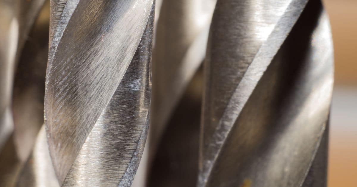 Closeup of several metal drill bits with spiraled flutes