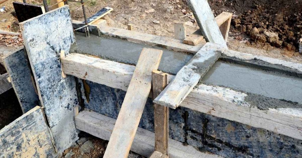 Wooden concrete forms filled with wet concrete at construction site